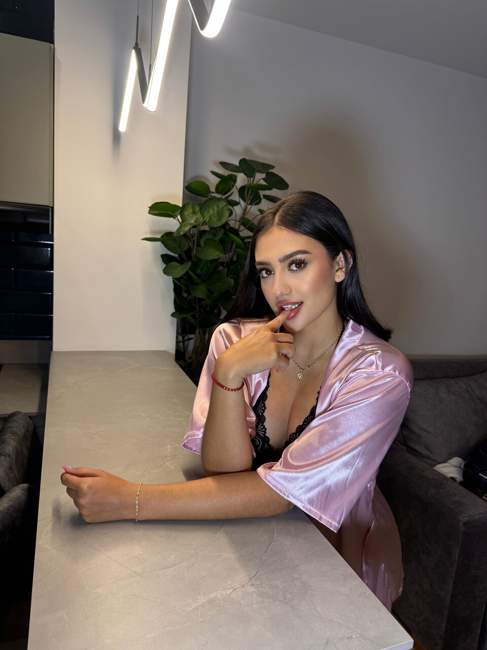 Brunette teen shows her teeth in revealing lingerie on a balcony