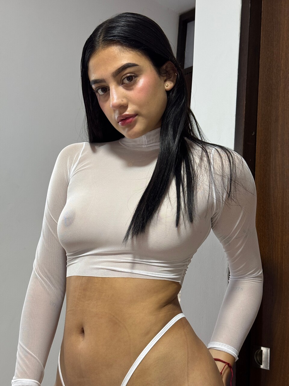 Brunette teen covers up her small tits while changing her underwear
