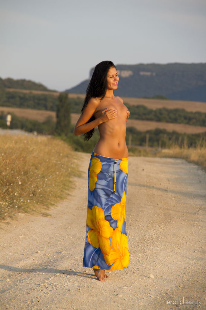 Dark-haired beauty strips to her birthday suit on a country road