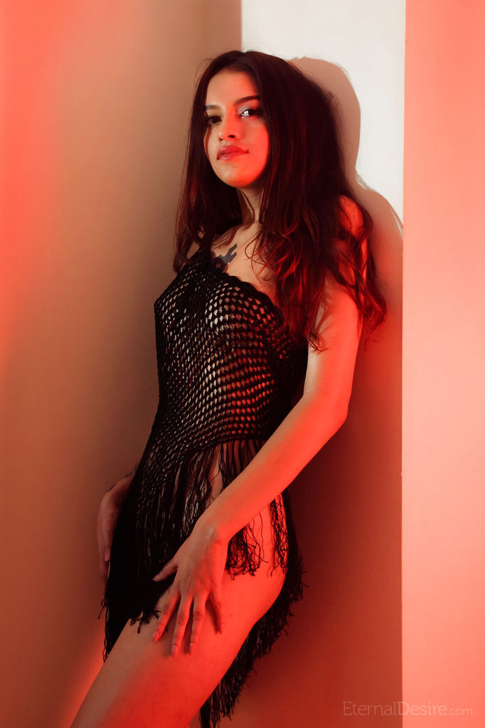 Brunette teen Liron Shein finger spreads her pussy while naked in red light