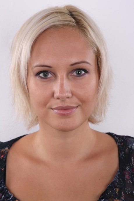 Blonde amateur strips of all her clothes to stand naked in a confident manner
