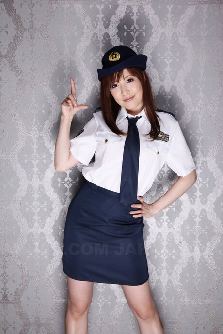 Japanese policewoman Akane Satozaki uncovers her small tits during a solo show