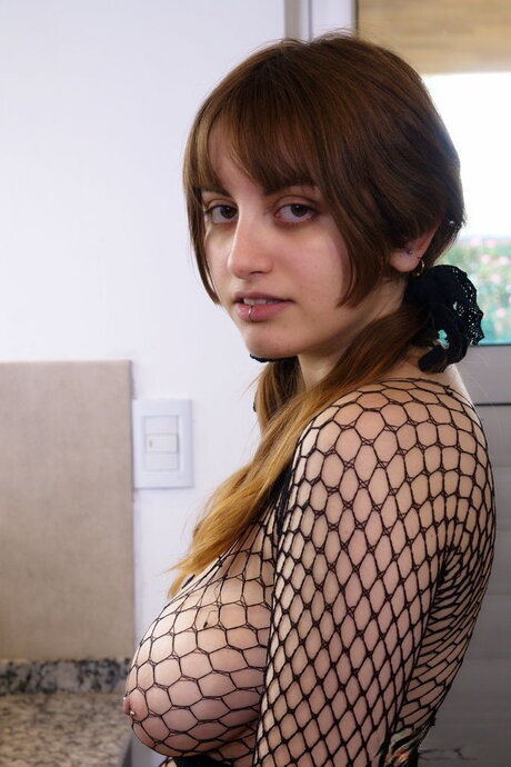 Busty teen Arya toys her pussy in a mesh top and black over the knee nylons