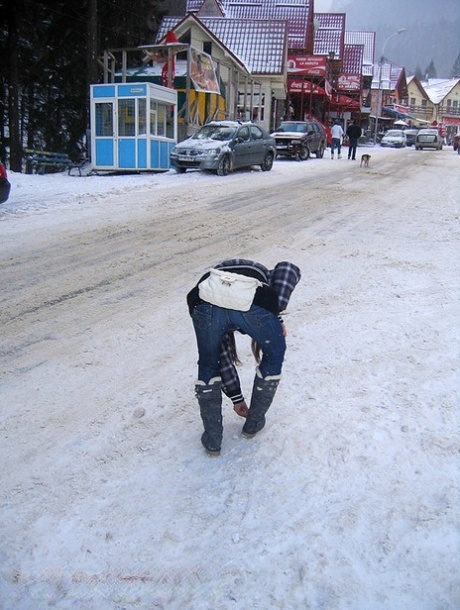 Amateur couple takes self shots while visiting a snow covered town