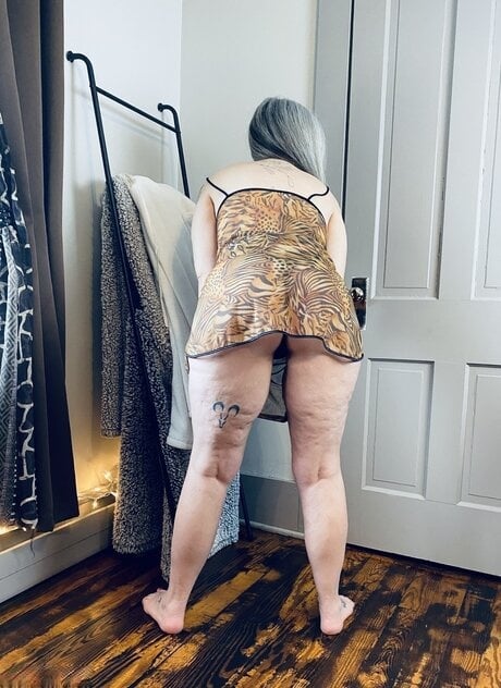 Platinum blonde amateur strips down to a black thong after donning a bathrobe