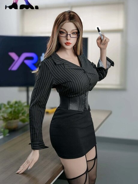 Hot female sex doll displays her great body on a desk in the nude