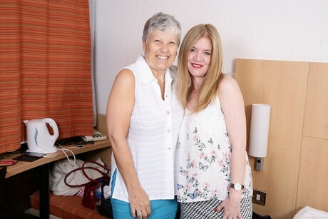 Old and young lesbians play with each others boobs while having sex on a bed