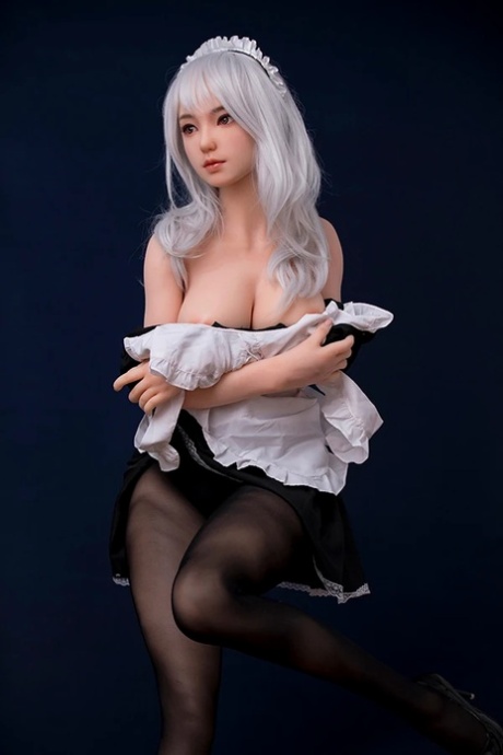 Pretty blonde maid sex doll removes her uniform and shows off her big tits
