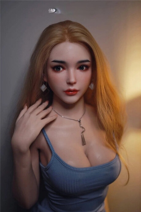 Pretty sex doll with long hair and a sexy dress posed for the camera