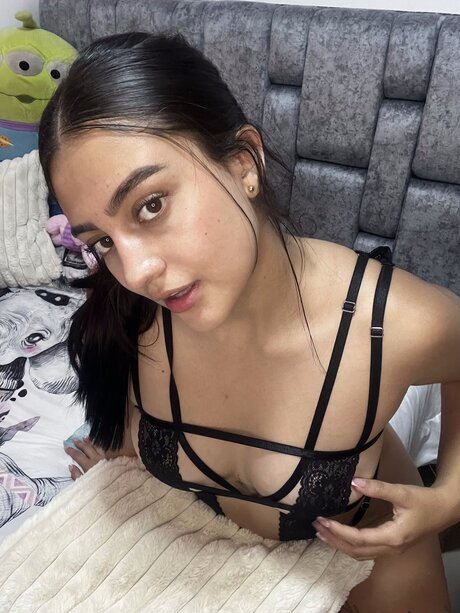 Solo girl takes a selfie while showing her underboob in sexy lingerie