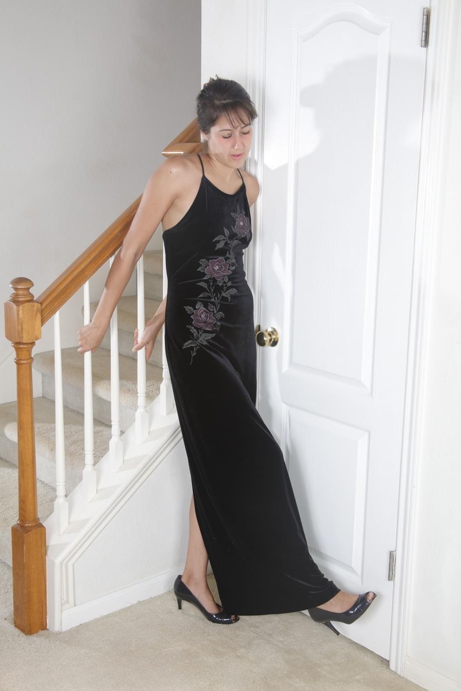 Over 30 female removes a black dress to get naked in front of a stairwell